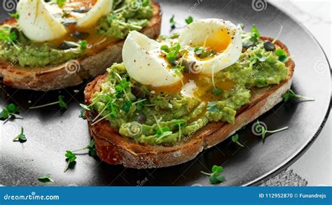 Healthy Avocado And Egg Toasts With Pumpkin And Sesame Seeds Sprinkled With Cress Salad Stock