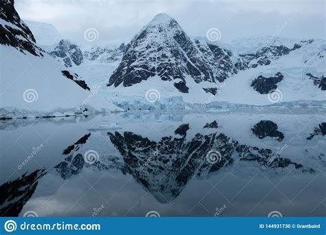 Antarctica Mountains and Glaciers Reflect in Mirror Blue Bay on Cloudy Day 3 Stock Photo - Image ...