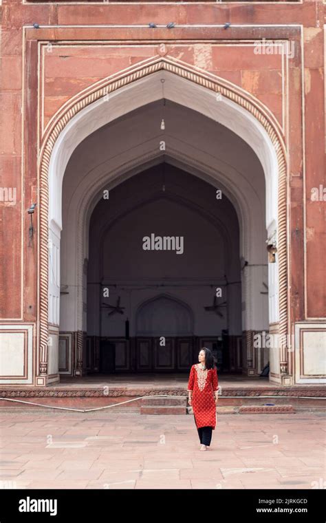 Ethnic Young Woman In Traditional Clothes Walking And Looking Away