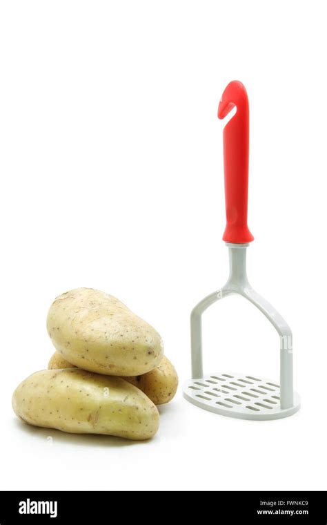 plastic potato masher with raw potato isolated on white background ...