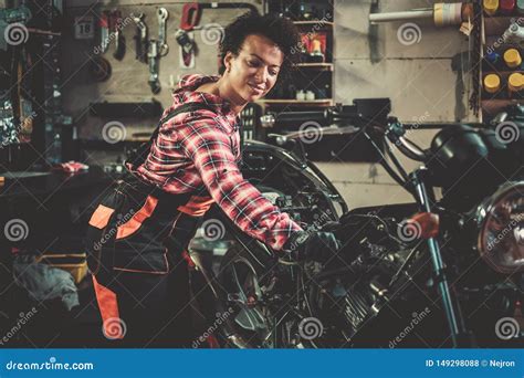 African American Woman Mechanic Repairing A Motorcycle In A Workshop