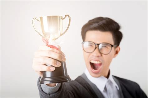 Premium Photo The Winner Holding Gold Trophy Studio Shot On White