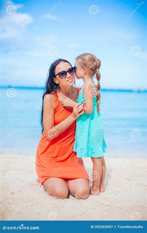 Beautiful Mother And Daughter At The Beach Enjoying Summer Vacation