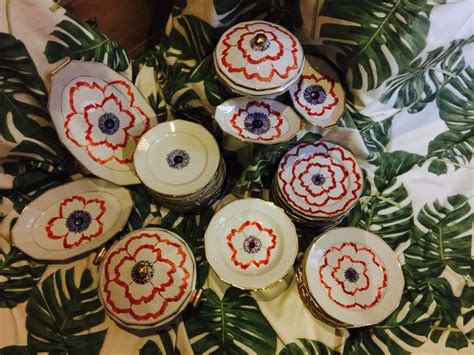 A Bunch Of Dishes Sitting On Top Of A Table Covered In Green Leafy Leaves