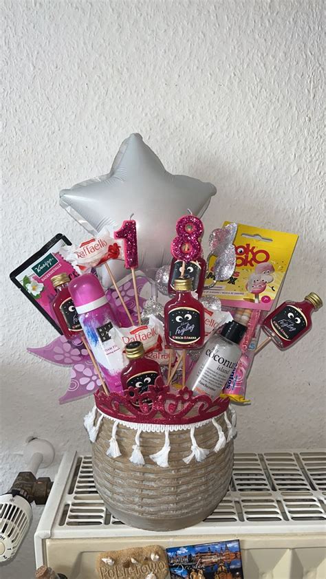 A Basket Filled With Lots Of Different Items On Top Of A Shelf Next To