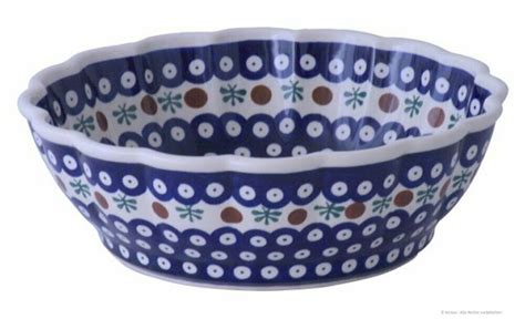 Two Blue And White Bowls Sitting Side By Side On A White Surface With