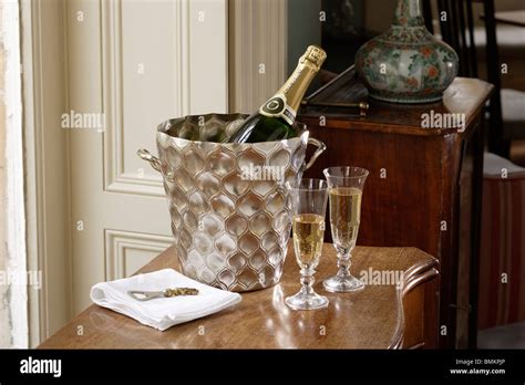 Champagne Cooling In An Ice Bucket With A Pair Of Glasses Stock Photo