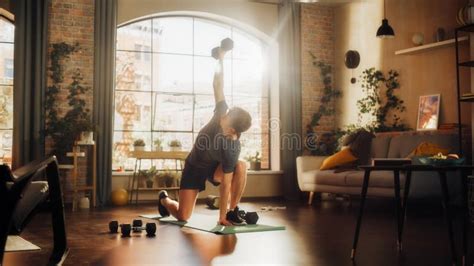 Strong Athletic Fit Young Man Training and Strengthening Arm Muscles with Dumbbell Exercises ...