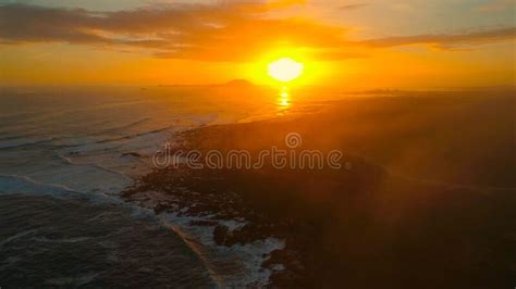 Lens Flare Beautiful Sunset Illuminates The Tranquil Ocean And Rugged