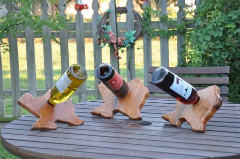 Three Wine Bottles Sitting On Top Of Wooden Stars