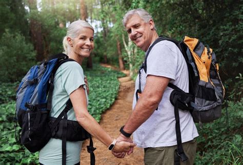 Portrait Of A Mature Couple Holding Hands While Out Hiking Together