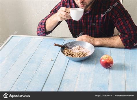 Man eating healthy breakfast Stock Photo by ©KucherAndrey 175943718