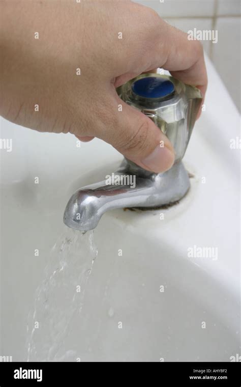 Hand Turning Tap Hi Res Stock Photography And Images Alamy