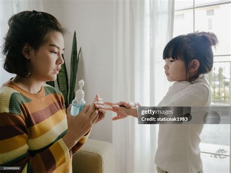 Mother Cleaning Her Daughters Hands With Alcohol Hand Sanitizer Protect