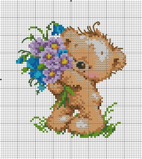 A Cross Stitch Pattern With A Teddy Bear Holding Flowers