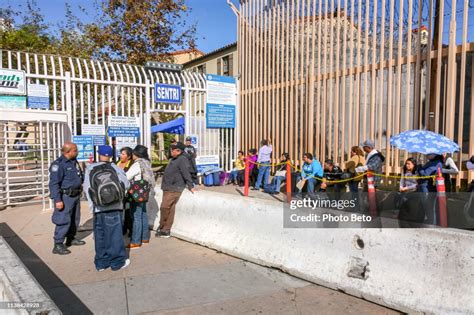 Some People Wait To Cross The Usmexico Border At The San Ysidro Port Of