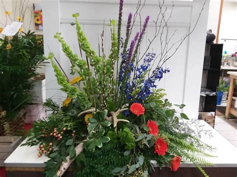 Grouped Casket Spray With Bells Of Ireland Blue Delphinium And Gerbera