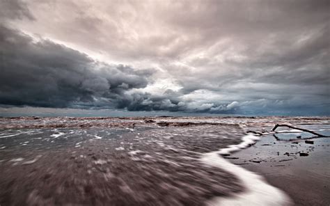 Timelapse Photography Of Seashore And Ocean Water Under Grey And White