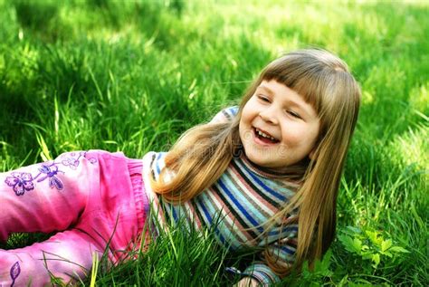 Smiling Little Girl on Grass Stock Image - Image of green, plays: 21728509