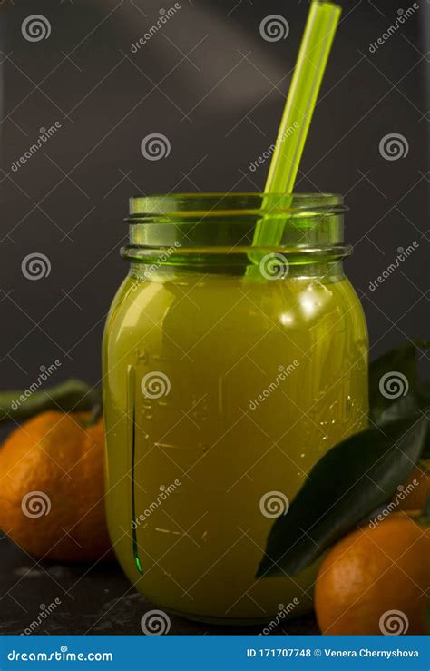 Freshly Squeezed Orange Juice In A Mason Jar And Fresh Oranges Fruit