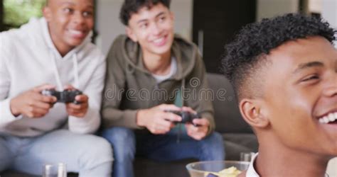 Happy Diverse Male Teenage Friends Playing Video Games at Home, Slow ...