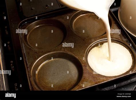 Pouring Yorkshire Pudding Batter Into A Pan Or Baking Tray With