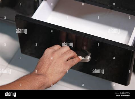 Man S Hand Open Drawer Wooden In Cabinet Stock Photo Alamy