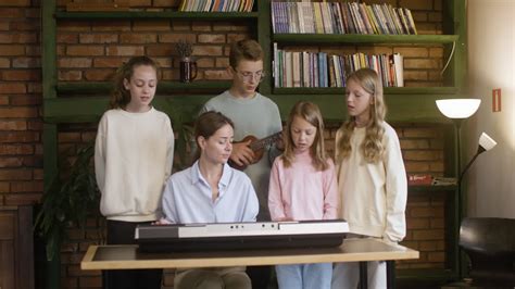 Free stock video - Teacher and kids singing and playing music at the school