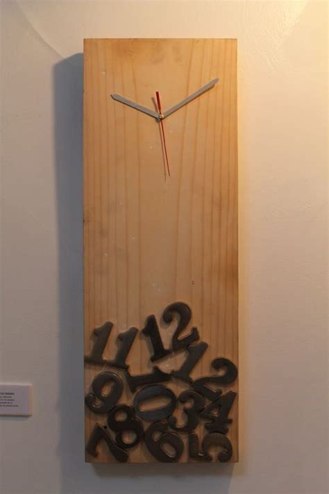 A Clock Made Out Of Wooden Letters And Numbers On A White Wall With A