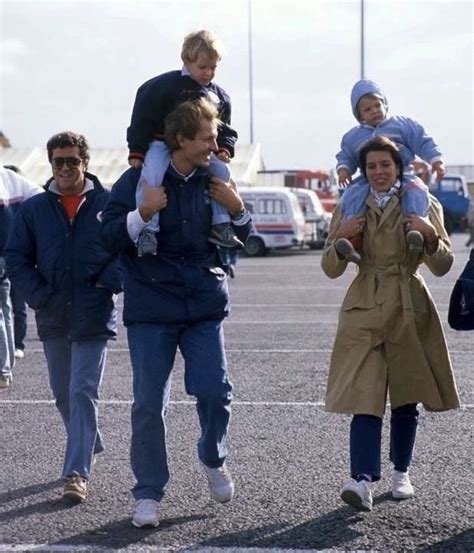 A Group Of People Walking Across A Parking Lot Holding Onto Each Other