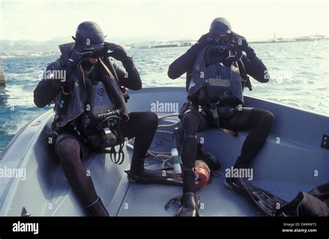 Navy SEALs combat swimmers in a utility boat adjust their dive masks Stock Photo - Alamy