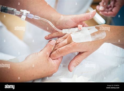 Nurse Preparing A Patient For An Iv Line Stock Photo Alamy