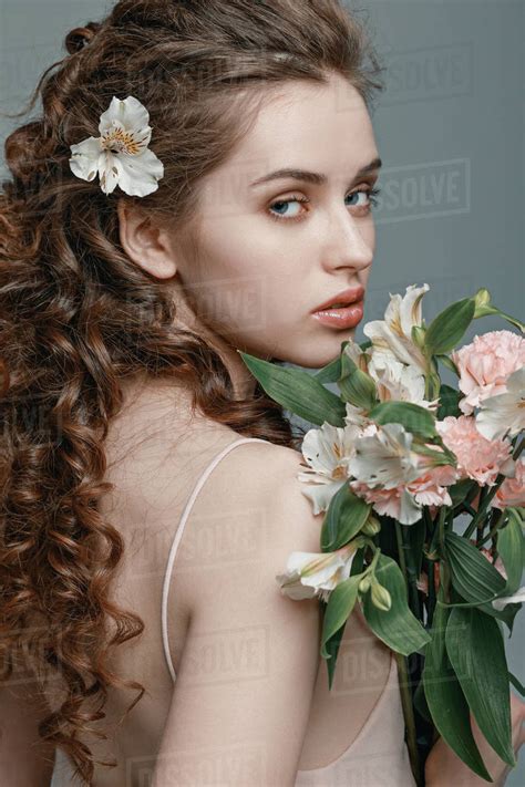 Side View Of Attractive Young Woman With Spring Flowers Bouquet