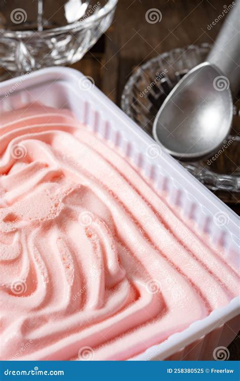 Box Of Strawberry Flavor Ice Cream With Scoop And Bowls Vertical