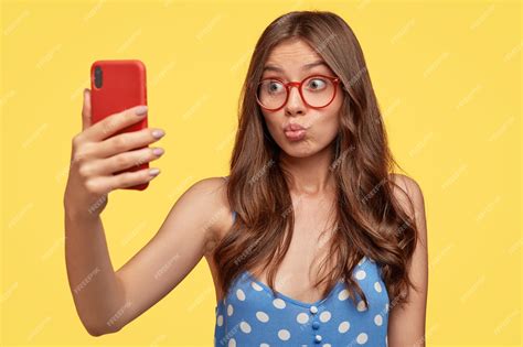 Free Photo Pretty Girl Takes Selfie Pouts Lips Of Cell Phone Makes