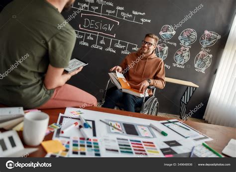 Brainstorming Cheerful Male UX UI Designer In A Wheelchair Holding A