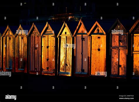 Beach Huts Glowing At Sunset Stock Photo Alamy