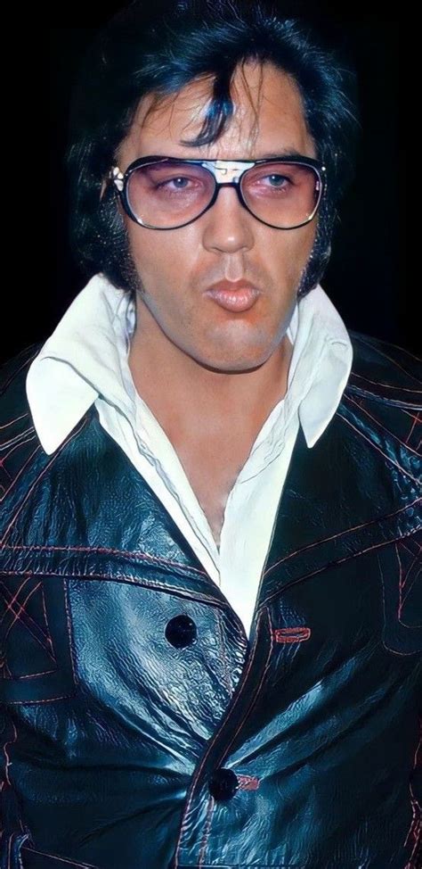 A Man Wearing Glasses And A Leather Jacket