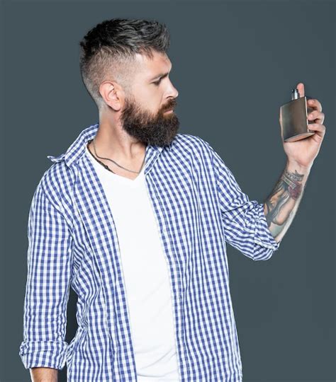 Premium Photo Handsome Mature Bearded Man Hold Male Perfume Bottle