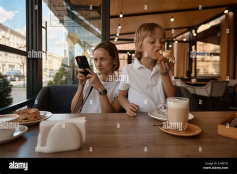 Mother And Son Having Lunch In Sidewalk Restaurant Mom And Son Eat A