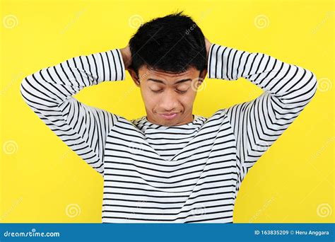 Portrait Of Funny Asian Man Showing A Sleepy Gesture Feeling Being