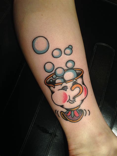 A Woman S Arm With An Elephant And Bubbles Tattoo Design On The Left