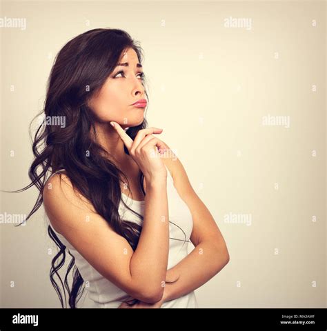 Confusion Grimacing Brunette Woman Thinking And Looking Up In White T