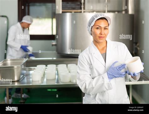 Woman Wearing Uniform Showing Cottage Cheese Production Process On