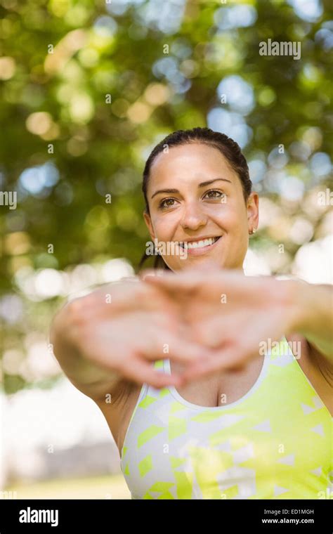 Athletic Brunette Stretching In The Park Stock Photo Alamy