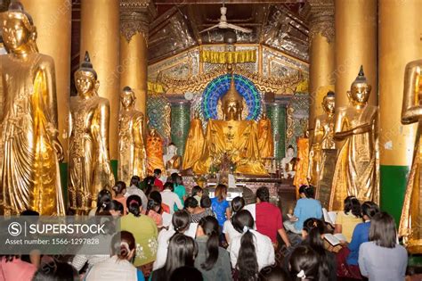 Worshippers Praying Inside A Prayer Hall At Shwedagon Pagoda Yangon