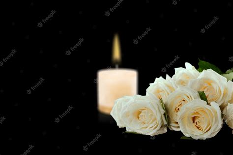 Premium Photo Beautiful White Roses With A Burning Candle On The Dark