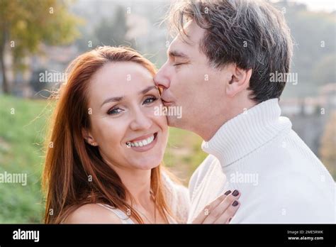 A Loving Couple Husband And Wife Hugging A Man Gently Kisses A Woman