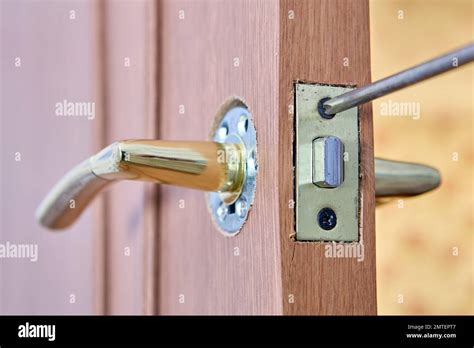 Repair of lever doorhandle with latch on an interior door Stock Photo ...