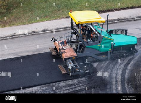 Asphalt Paver Machine Or Paver Finisher Places A Layer Of Fresh Hot